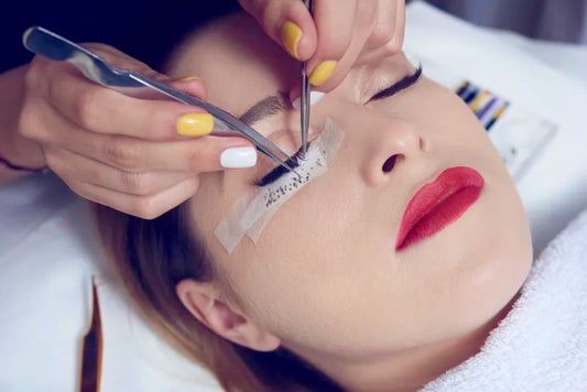 A woman getting eyelash extensions at a beauty salon